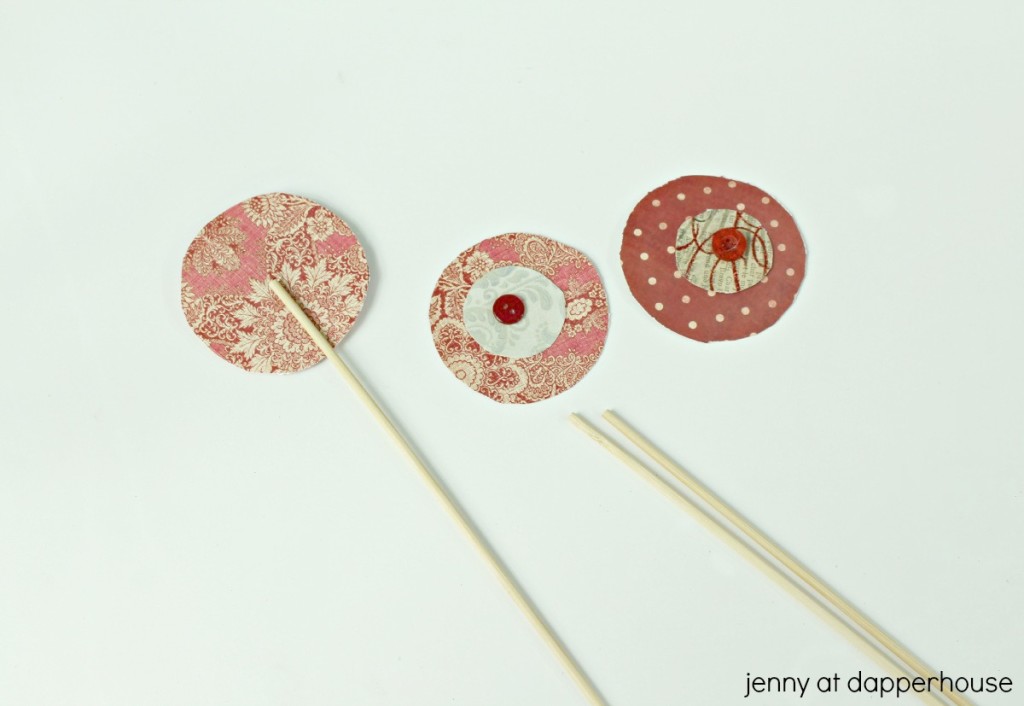 Use the glue gun to attach a wooden skewer to the back of each flower